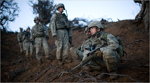 American infantry stripped down to as light as they can possible be with all the modern force protection gear.  There is only one way to fight insurgents in mountainious terrain and that is with no body aromor, no helmets, just a little food, water and ammo. Anyone who thinks they can do thte job in body armor and helmets is a deluded fool who have never humped the mountains of eastern Afghanbistan.  Photo by Tyler Hicks of the New York Times