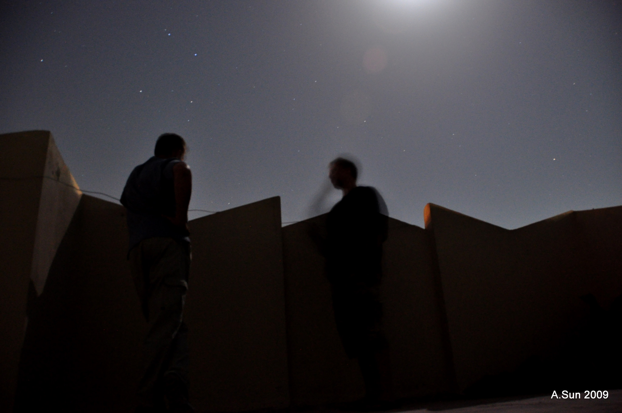 Myu Canadian colleague and I watching a brief fire fight at police checkpost in district four of Kandahar City - this incident aside the level of violence this year is considerably less than the same period of 2008. 