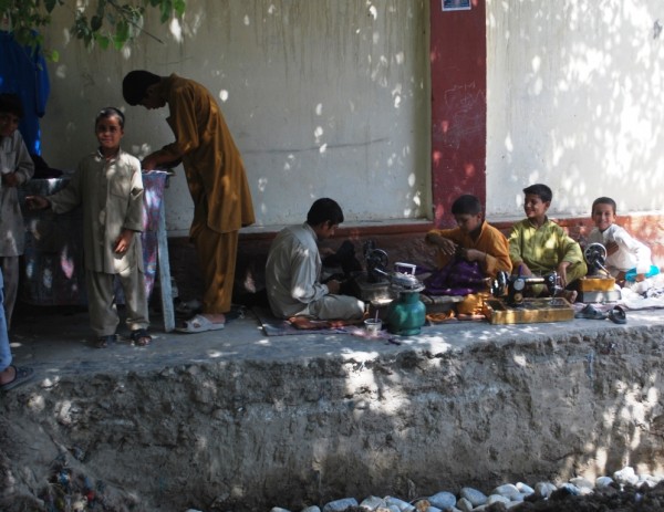 Some boys in Jalalabad working out in the shade (104 during the day now) - guess what their Dad does for a living?