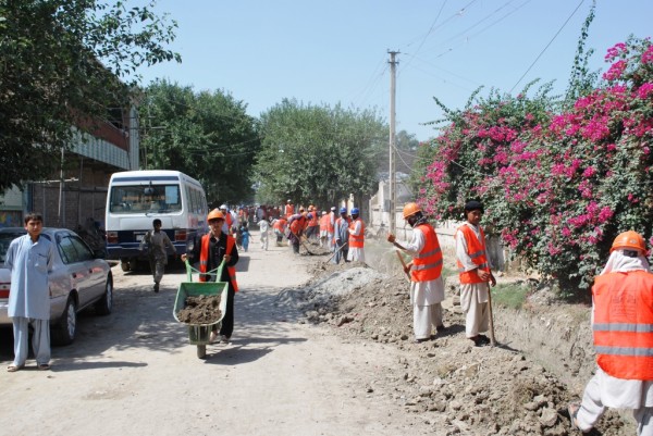 Building roads in downtown Jalalabad the old fashion way