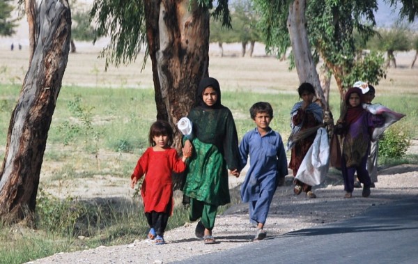 Children from a refugee camp outside of Jalalabad heading out to scavage for animal forage