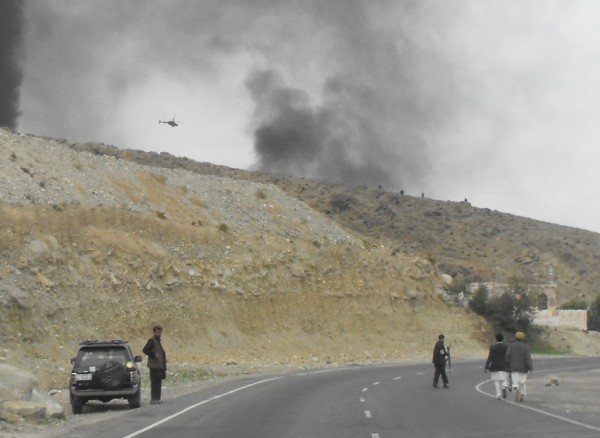 Approaching the ambush site - note the armed civilian - who knows who he is - running towards the firing. What is also important to note is the lack of any vegitation or cover in the hills where the bad guys are and the Amry OH 58 Kiowa circiling overhead. 