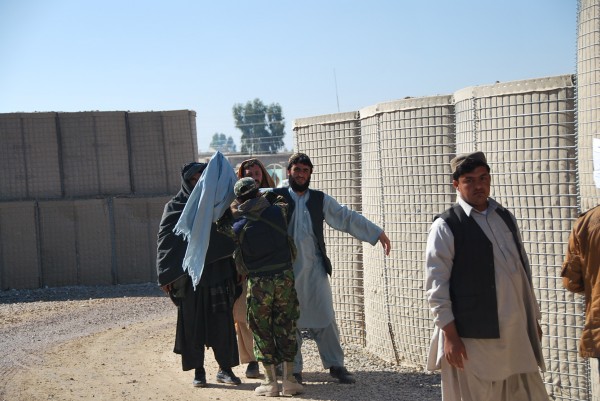 This picture was taken today outside on of our secure bases in the Helmand - that is a local Afghan guard doing the searching. I asked the ISAF guys at the gate who that guard was and how long he had been working for them. They had no idea. 