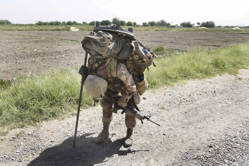 There is nothing easy about opoerating on foot outside the wire when you have to carry everything on your back - especially if you are from the 81mm mortar platoon. Photo by David Guttenfelder