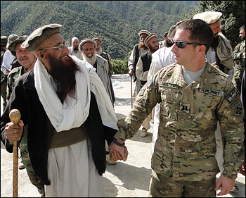 By all news accounts the soldier in this picture, Captain Mark Moretti is an exceptional combat leader who knows the business well.  but this picture makes my blodd boil.  I am all for pulling out of the Korengal Valley and have said repeatedly we should never have gopne there in the first palce.  But to pull out like this - holding hands with the local chief villian - him smiling like he just won the lottery because he now owns the milliond of dollars of gear left behind and he gets to hold hands with the last American commander as if a Captain in the Army is his bitch?  We should have pulled out and when Haji dip shit and the local Taliban arrived the next day to flaunt their new prize we should have JDAM'd the whole group.  Yes it is important that the Afghans undersatnd we are a just people who respect the rule of law and are motivated by a sense of justice etc.... but it helps to let them also know we are unpredictable and powerful too  And that we don't give a shit about Korengali villagers anymore.  You know what I call that kind of tactic?  Force Protection...the old fashion way.