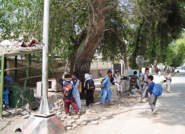 The day after the bike IED attack local school children exam the scene