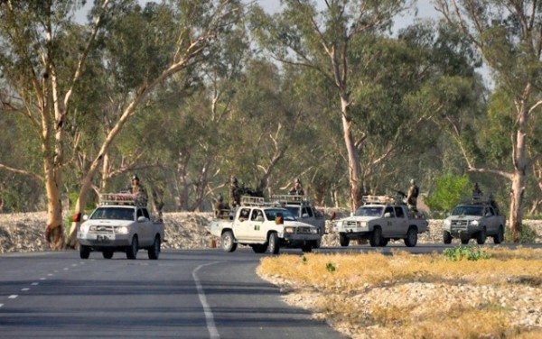 Afghan Commandos with embedded American SF pause for a radio check outside their base in Jalalabad. They are heading towards the Southern Triangle which contains Taliban units who operate day and night and have driven the Afghan Security Forces out of many districts.